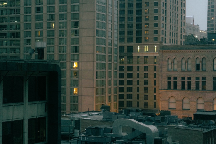 Evening lights in the windows above Chicago rooftops
