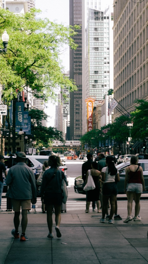 Pedestrians and the Chicago Theatre on State Street