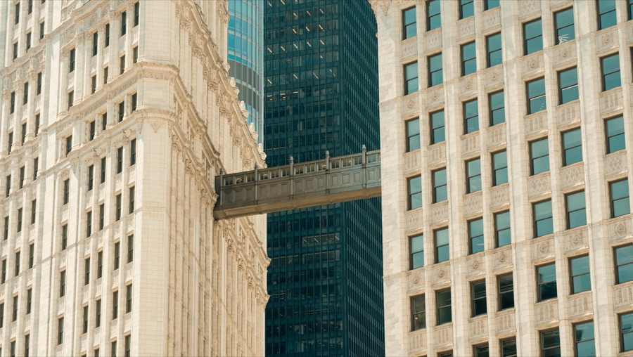 A skybridge between pale stone towers