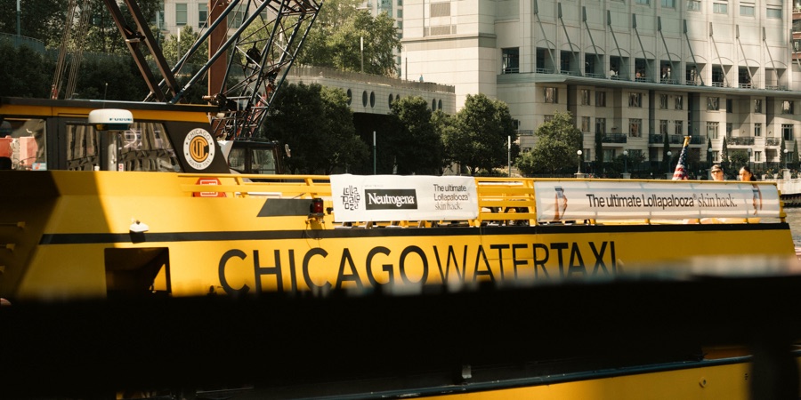A yellow Chicago Water Taxi passing on the river