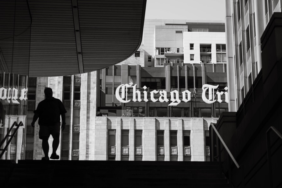 A silhouette beneath the Chicago Tribune sign